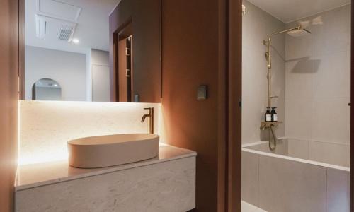 a bathroom with a sink and a mirror at Brown Dot Hotel Andong Taehwa in Andong