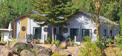 a house with a lot of rocks in front of it at Farm Terrace in Kaengsopha