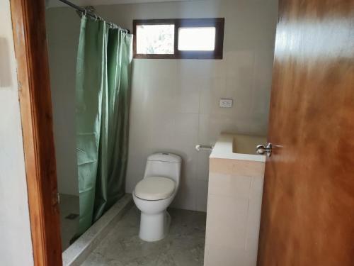 a bathroom with a toilet and a sink and a shower at Serena Grau in San Antero