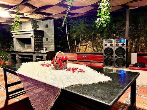 a table with a basket of flowers on top of it at Tuscany Villa Jarash in Al Madwar