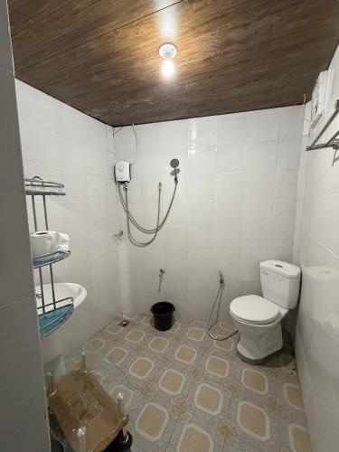 a bathroom with a toilet and a sink at LD Ignacio Island Resort in Roxas