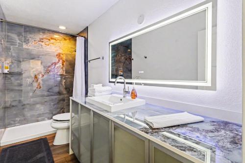 a bathroom with a sink and a toilet at Downtown Omaha - Elevated Studio & 1-Bed Stays in Omaha