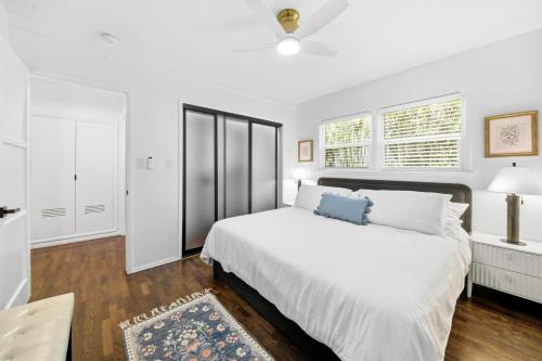 a white bedroom with a large bed and a window at Venice Venice in Los Angeles