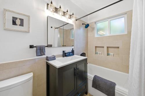 a bathroom with a sink and a toilet and a mirror at Venice Venice in Los Angeles