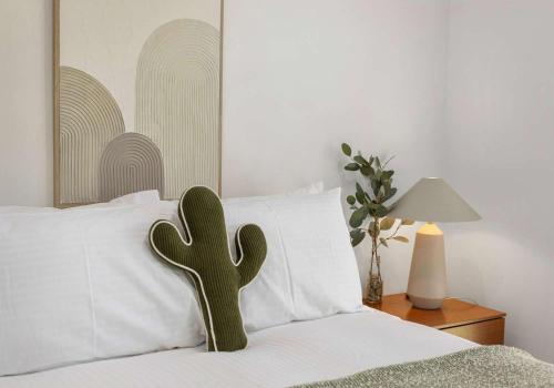 a cactus sitting on top of a white bed at Flinders Hideaway in Shellharbour