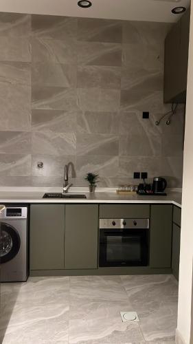 a kitchen with a sink and a stove at Velora Suites in Abha