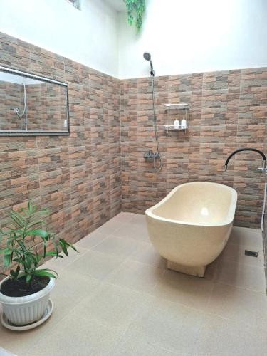 un bagno con vasca e pianta di Dacha a Bukittinggi