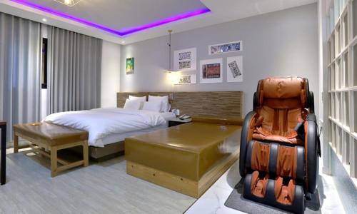 a bedroom with a bed and a desk and a chair at The Stay Series in Daegu
