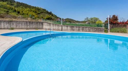 a large swimming pool with blue water at Geoje Erion Pet-Friendly Pension in Geoje