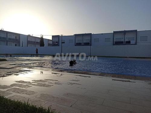 a pool of water in front of a building at mona in Sidi Rahal