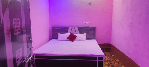 a small pink room with a bed in it at Hotel Sunrise inn in Nārdiganj