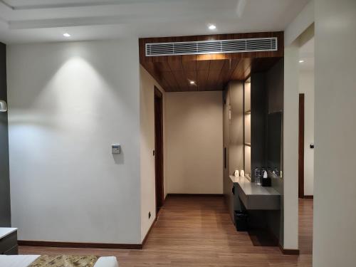 a hallway with a bathroom with a sink at The Holy Awadh Hotel in Ayodhya