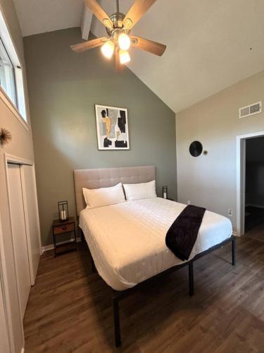 a bedroom with a bed with a ceiling fan at 2 King Suites w/ Private Baths + Workspaces | LSU in Baton Rouge