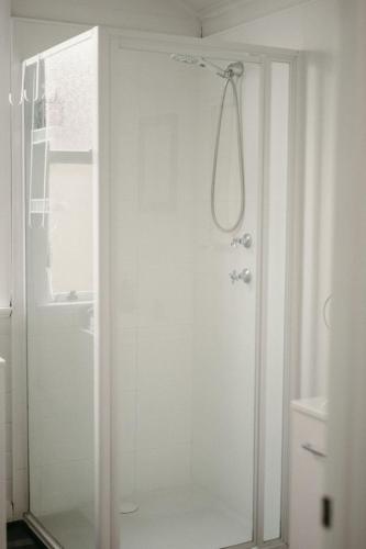 a bathroom with a shower with a glass door at Heritage Hideaway in Bunbury