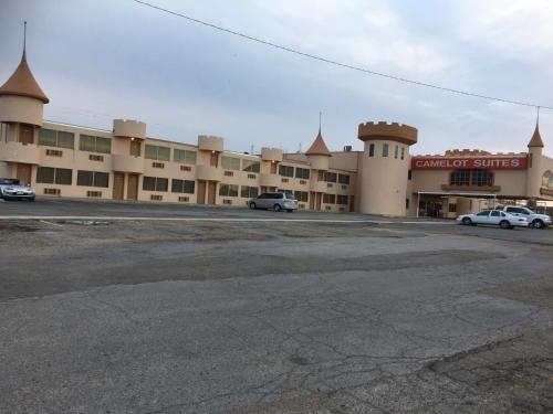 an empty parking lot in front of a building at Camelot Inn in Amarillo