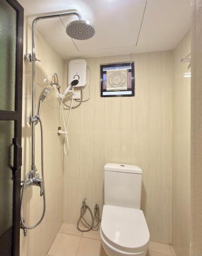 a bathroom with a shower and a toilet in it at JL Suites Calbayog in Calbayog