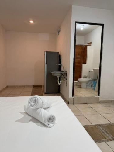 a bathroom with a towel laying on the floor next to a sink at Casa Dixam Luum in Puerto Morelos