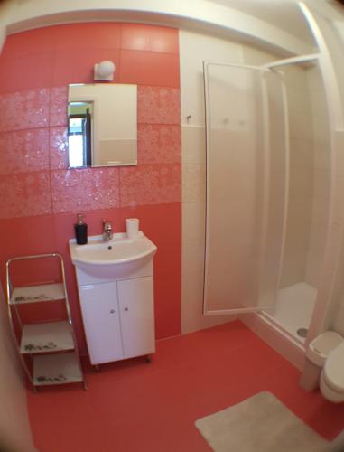 a bathroom with a white sink and a shower at Apartman Donovaly Panorama 31C 4i in Donovaly