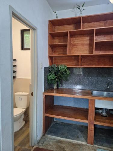 a bathroom with a sink and a toilet at Lio House 2 bedroom in El Nido Airport