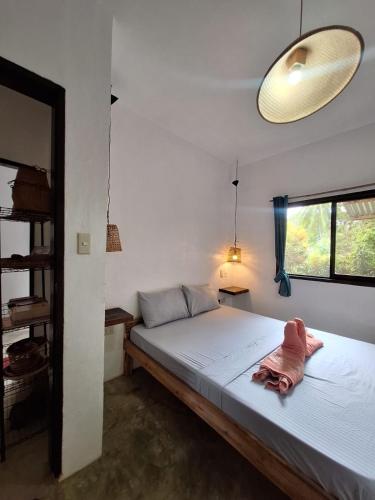 a bedroom with a bed with a stuffed animal on it at Lio House 2 bedroom in El Nido Airport