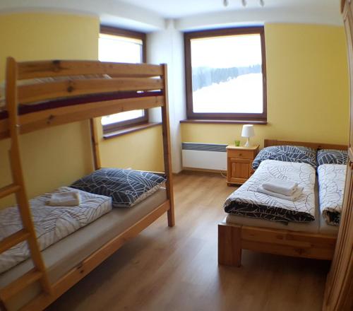 A bed or beds in a room at Apartman Donovaly Panorama 31C 4i
