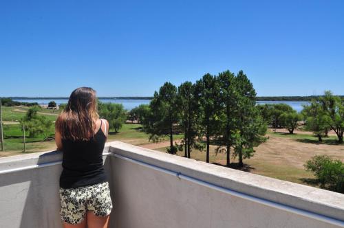 a woman standing on a wall looking at the water at Los Abus in Colón