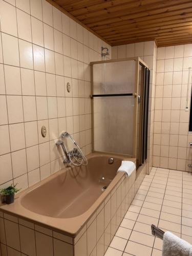 a large bath tub in a tiled bathroom at Ferienhaus Seilerbahn 17 in Vallendar