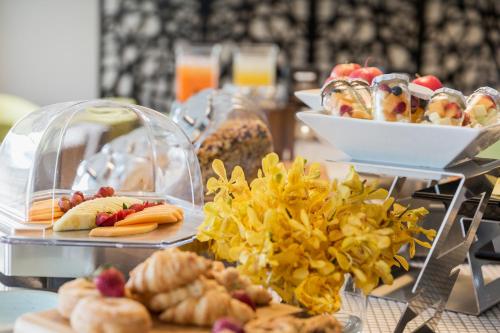 a buffet with plates of food on a table at PARKROYAL Parramatta in Sydney