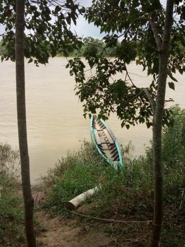 a boat sitting on the shore of a body of water at Tambopata River in Puerto Maldonado