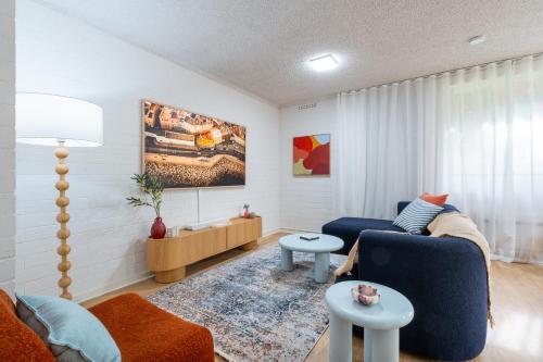 a living room with a couch and a table at Park side on East Terrace in Adelaide