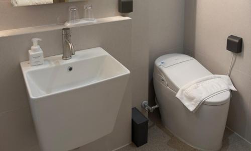 a small bathroom with a sink and a toilet at Pohang Daejamdong Route 422 in Pohang