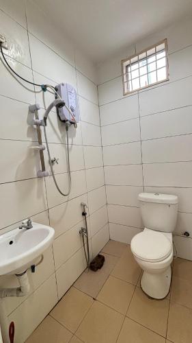a bathroom with a toilet and a sink at Ayem Resort Langkawi in Air Hangat