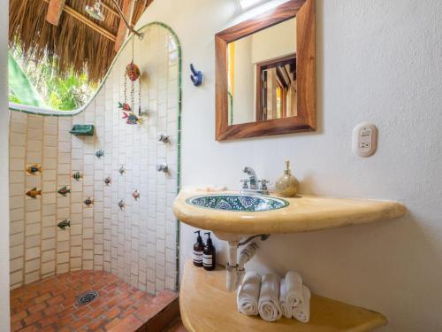 a bathroom with a sink and a shower at Amare Las Villas in Sayulita