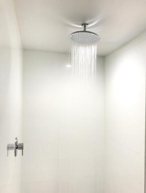 a bathroom with a ceiling fan and a chandelier at Ramsey Inn & Suites in Ramsey