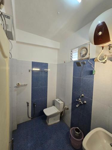 a small bathroom with a toilet and a shower at Hotel The King's in Port Blair