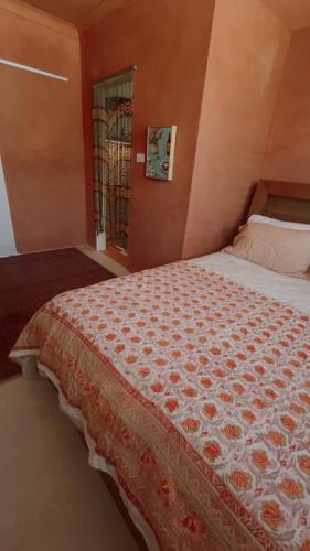 a bedroom with a bed with a red wall at Le Maroc at Bar Beach in Newcastle
