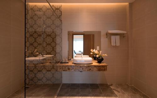 a bathroom with a sink and a mirror at Gold View Boutique Hotel Đà Lạt in Da Lat