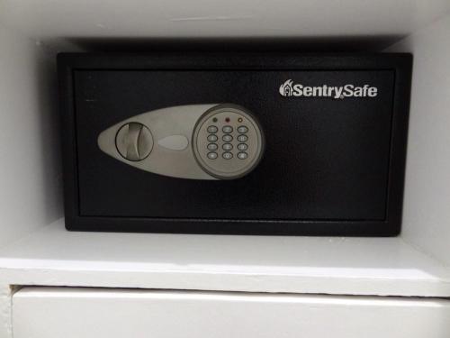a microwave with a remote control on top of a drawer at The Executive Villa Inn & Suites in Davao City