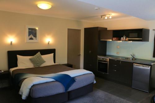 a hotel room with a bed and a sink at Abaco on Jervois in Auckland