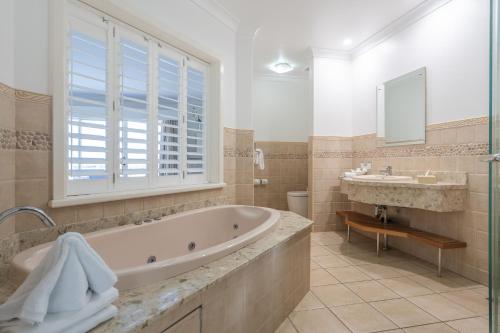 a bathroom with a tub and a sink at Harrington River Lodge in Harrington