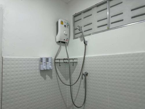 a shower in a bathroom with a shower head at Kasalong stay in Ban Nong Chaeng