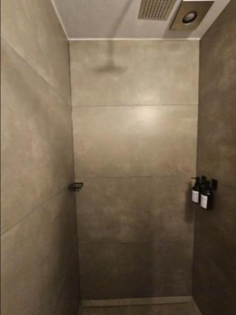 a shower with a glass door in a bathroom at Casa Tabacalera in Mexico City