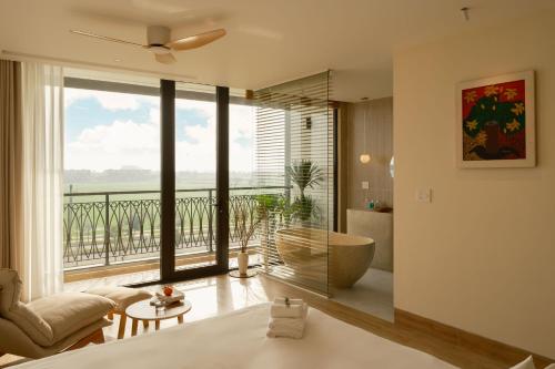 a bedroom with a bed and a large window at Elora House in Thôn Lại Thê
