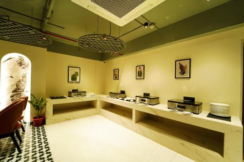 a restaurant with a waiting room with tables and counters at The Saffron Hotel in Bhubaneshwar