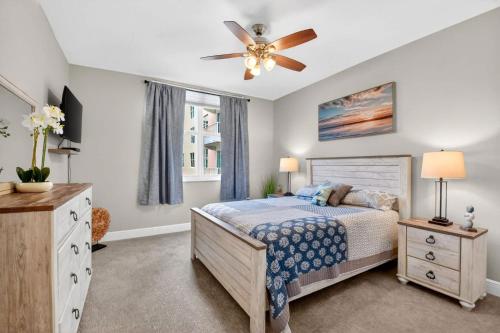 a bedroom with a bed and a ceiling fan at Moorings Pool Overview Resort in Lantana
