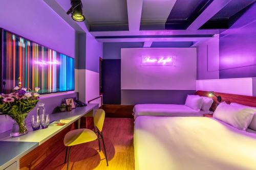 a purple bedroom with a bed and a desk at HYVE Jerusalem hosted by STAY in Jerusalem