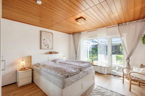 a bedroom with a bed and a wooden ceiling at Zipper Burgblick Otzberg Odenwald in Hering