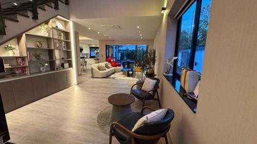 a hallway with chairs and a living room at Vantara Private Villa Chiang Mai in Chiang Mai