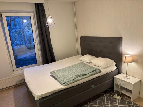 a small bedroom with a bed with a window at Cozy Apartment with Private Sauna in Vaasa