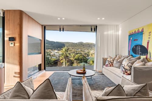 a living room with a couch and a table at Casa Celeste, Grand Architectural Residence in Wollongong